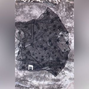 A black see through crop top with non see through stare. The neckline is wavy.